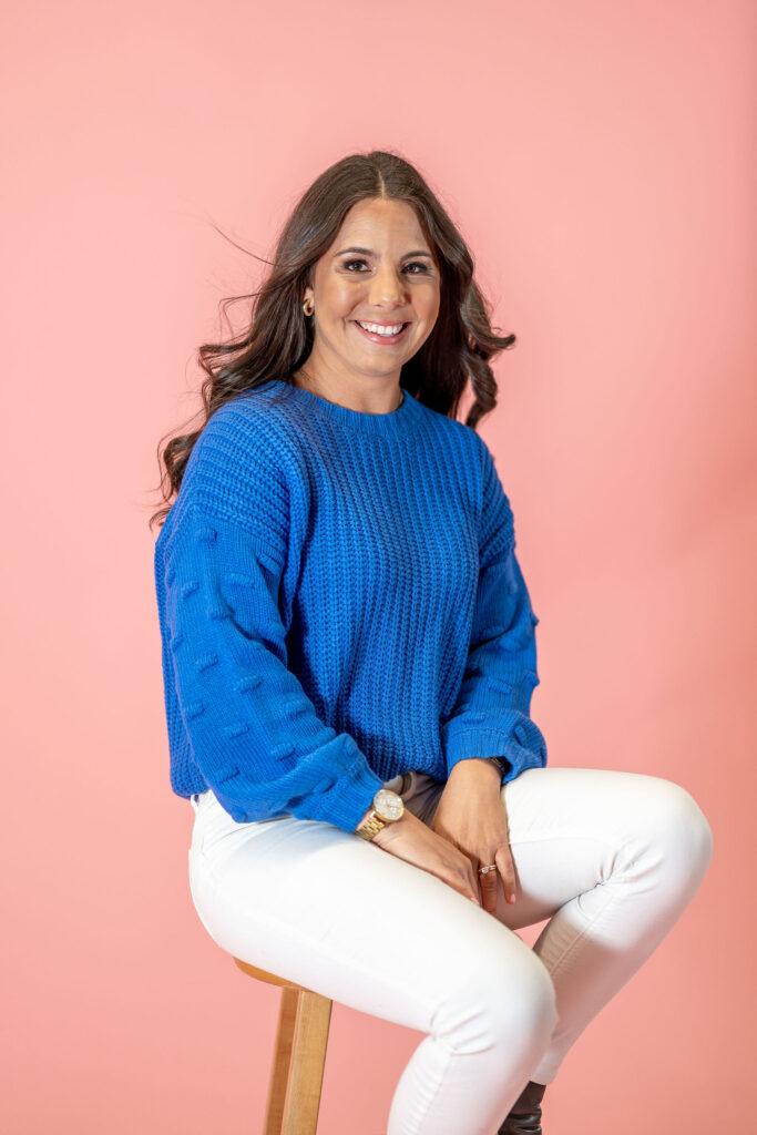 Stephanie in front of pink backdrop